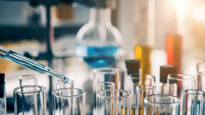 Chemicals are dropped into containers using a pipette